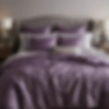 Elegant purple and gray comforter set arranged on a stylish bed