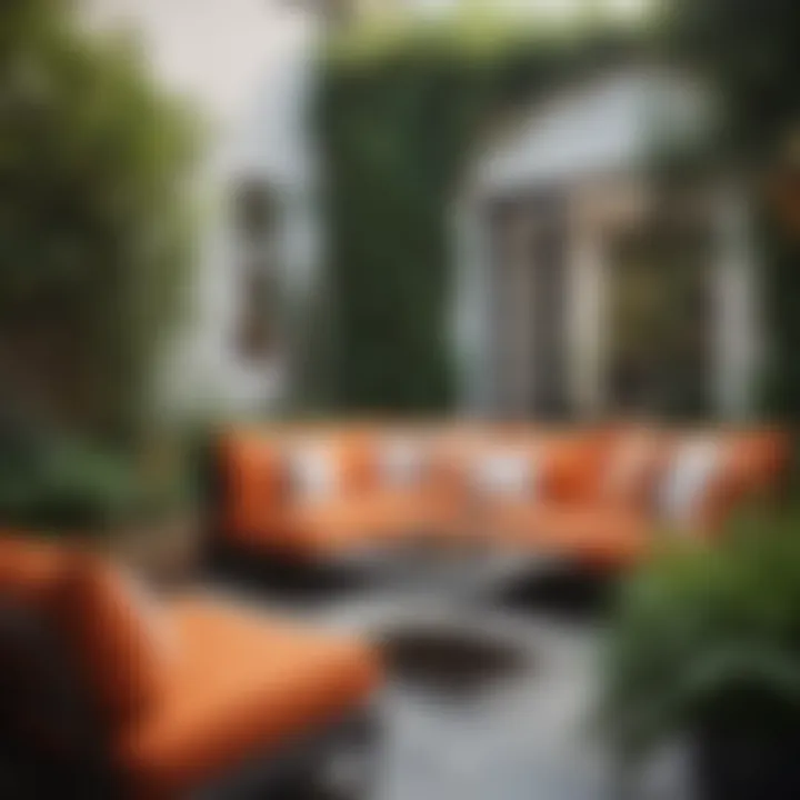 Stylish outdoor seating area with orange cushions and greenery