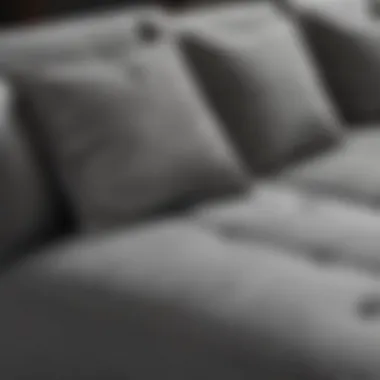 Close-up of the fabric texture on a gray sofa with chaise lounge